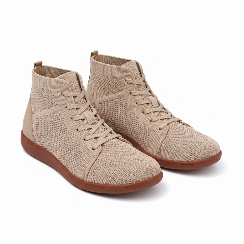A pair of beige high top lace up sneakers with a textured knit upper and brown soles.