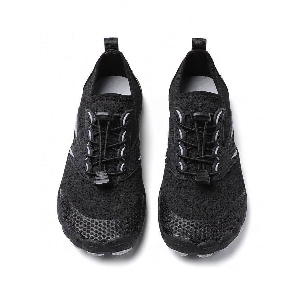 A pair of black water shoes with textured soles and lace up fronts, shown from a top down view.