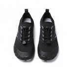 A pair of black water shoes with textured soles and lace up fronts, shown from a top down view.