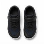 A pair of black children's barefoot shoes  with hook and loop strap closures, black laces, and a subtle dark blue dotted pattern on the side panels, shown from a top down view.