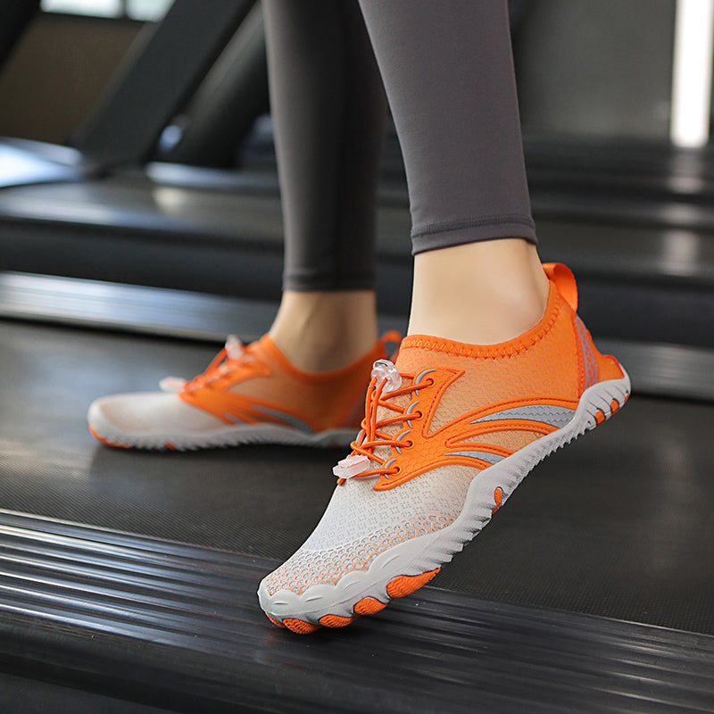 Orange and white athletic shoes on a treadmill worn by a model