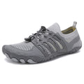 Grey athletic shoe with black laces.