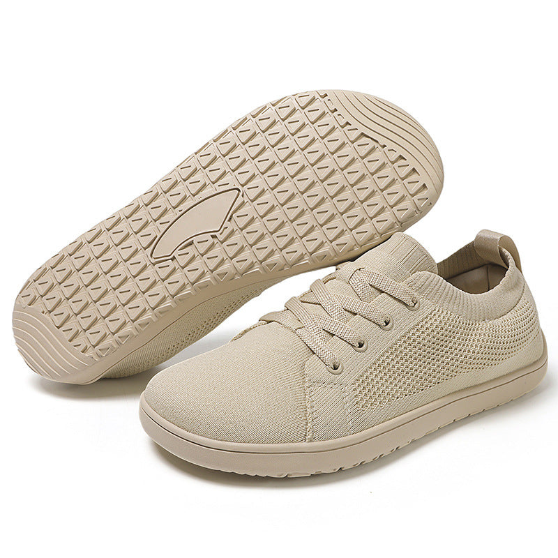 Beige sneakers with textured sole.