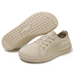Beige sneakers with textured sole.