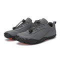 A pair of Men's Barefoot dark grey and black athletic shoes with a breathable mesh upper, lace up front, and rugged treaded soles.