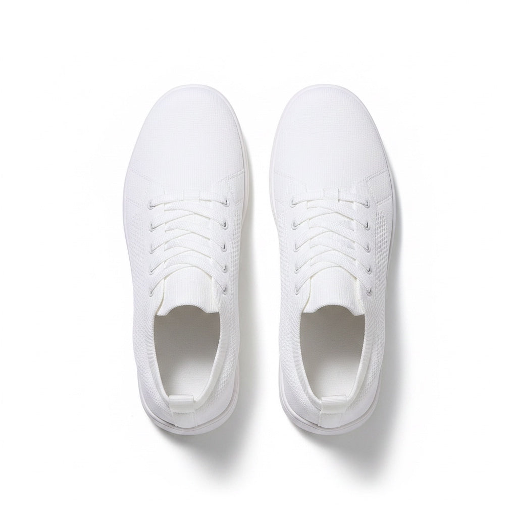 A pair of white low top lace up sneakers shown from a top down view. 