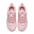 A pair of light pink athletic sneakers shown from a top down view. 