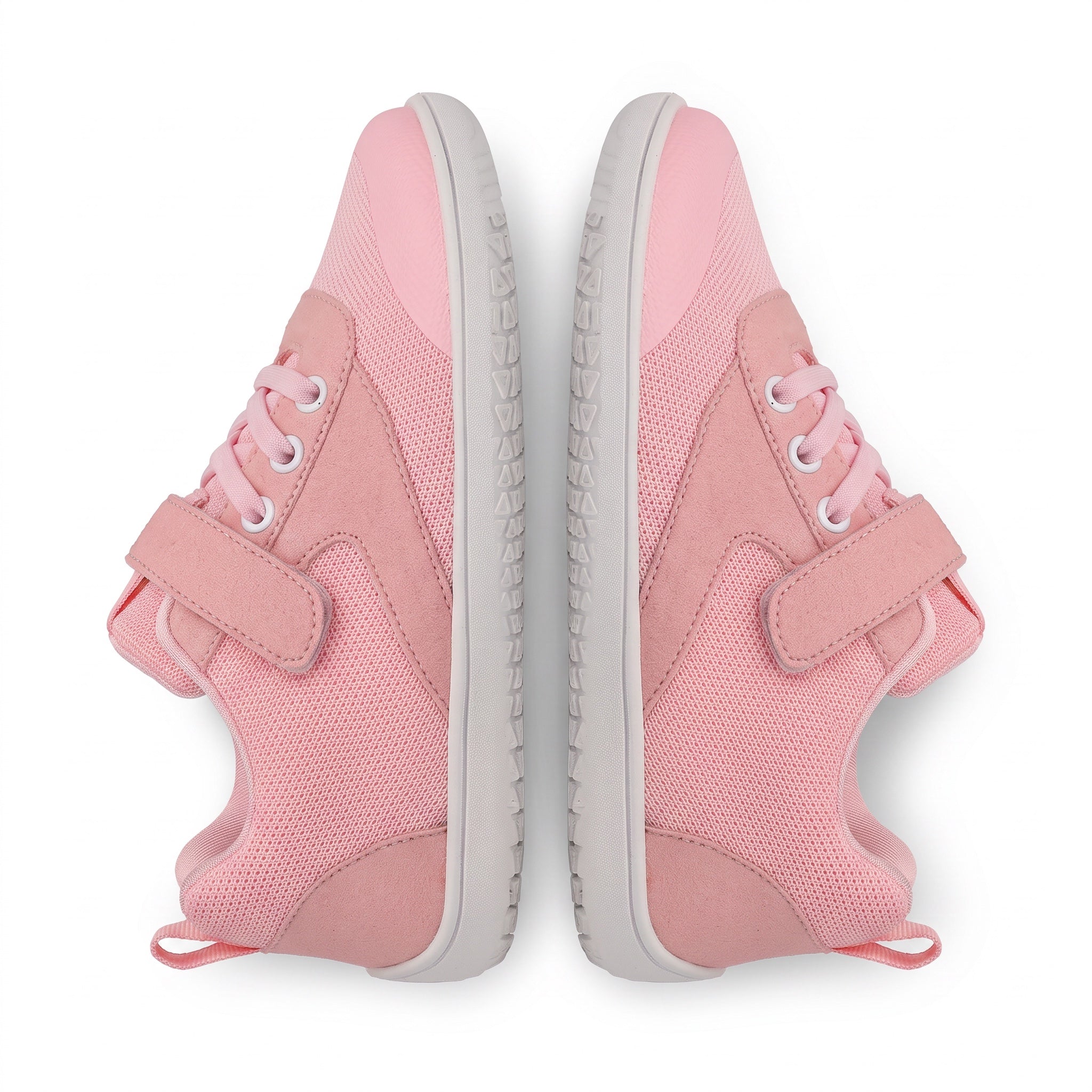 A pair of pink children's barefoot shoes shown from a top down view on a white background. The sneakers feature a mesh and suede like upper, pink laces, hook and loop strap closures, and light grey soles.