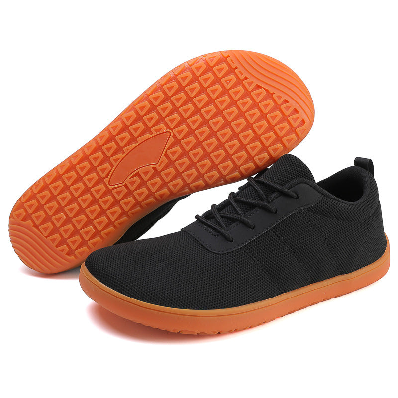 Black Barefoot shoe with orange sole.