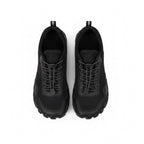 A pair of Mens black athletic Barefoot shoes shown from a top down view 