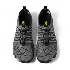 A pair of water shoes in grey and black with a geometric pattern and neon green accents, shown from a top down view.