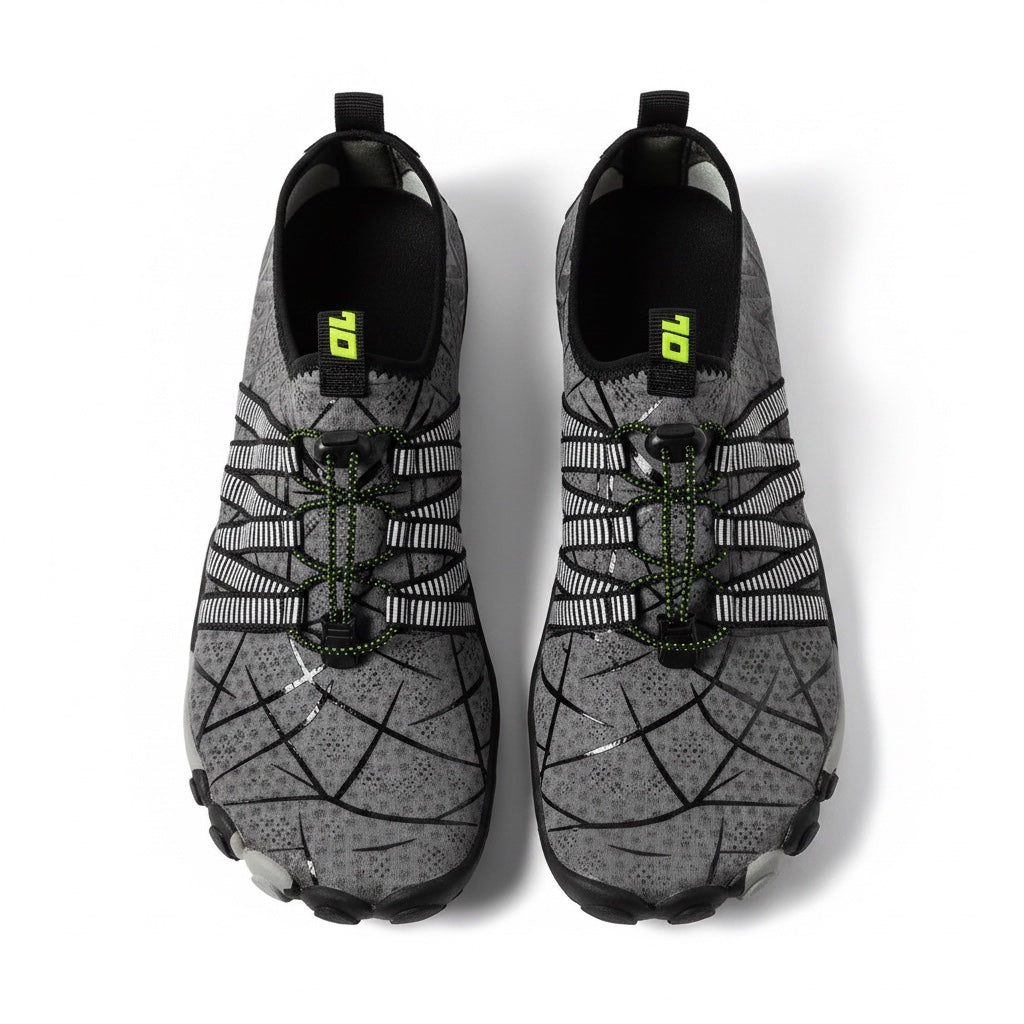 A pair of water shoes in grey and black with a geometric pattern and neon green accents, shown from a top down view.