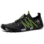Black and grey athletic shoe with green accents.