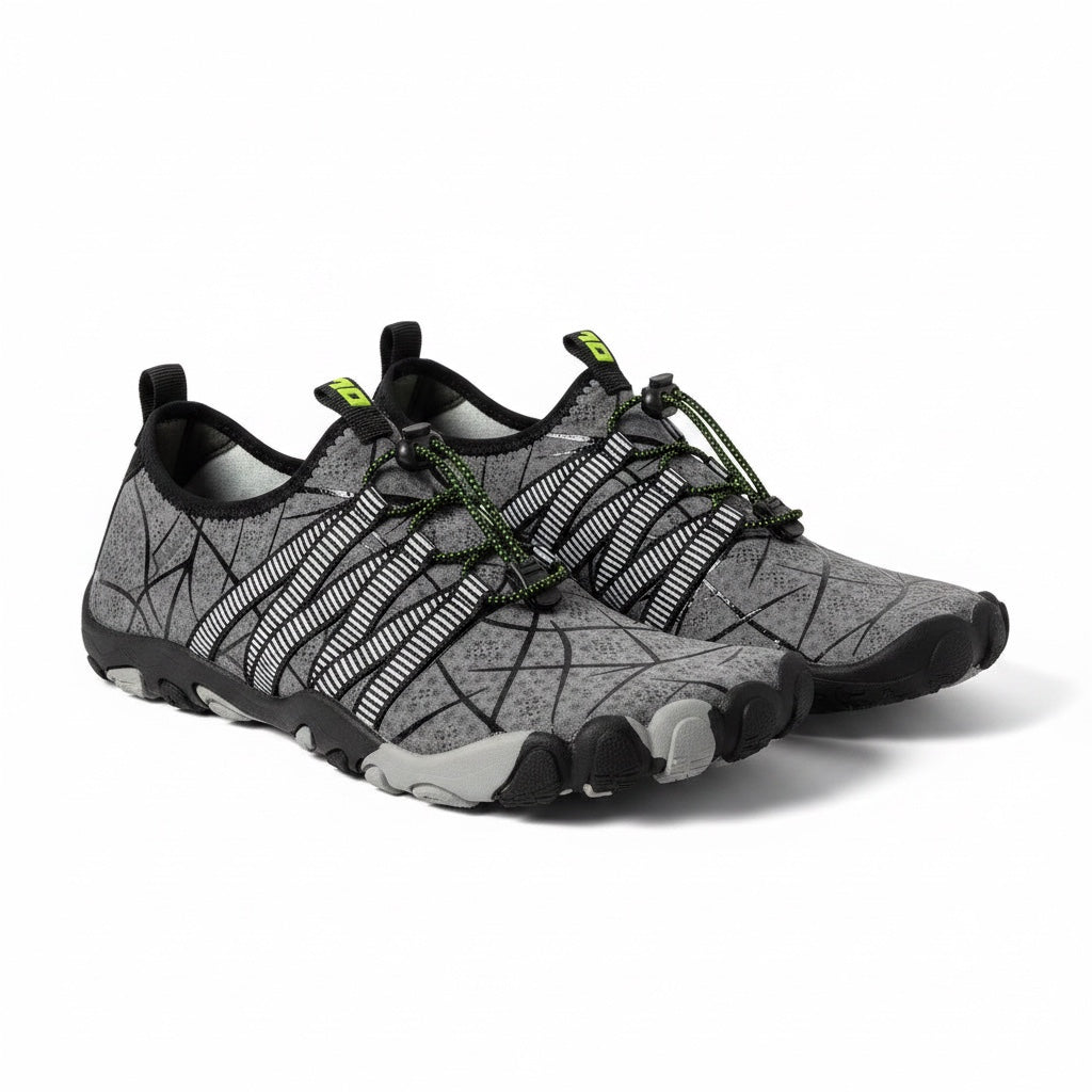 A pair of minimalist water shoes in grey and black with green accents.