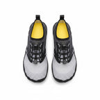 A pair of water shoes shown from a top down view. The shoes feature a black and grey mesh upper with black laces, a light grey textured lower section, and a bright yellow interior lining.