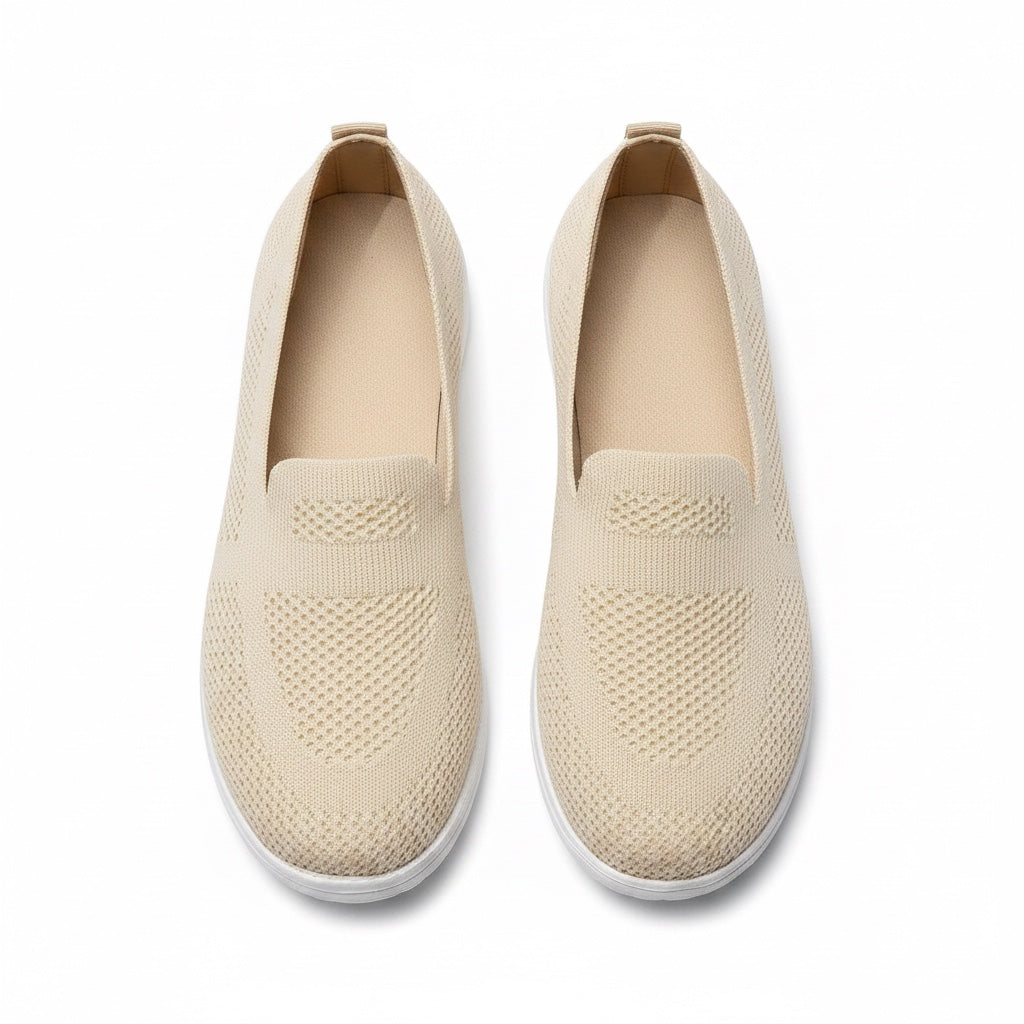 A pair of slip on knit Loafers shoes in a light beige colour with white soles.