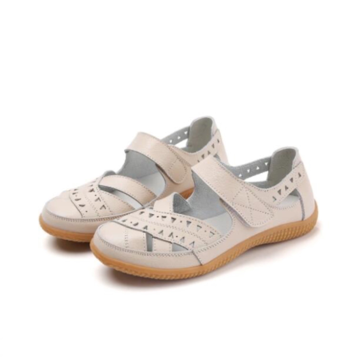 Pair of Beige women's comfort sandals with adjustable straps and brown soles