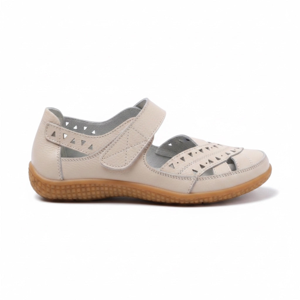 Pair of Beige women's comfort sandals with adjustable straps and brown soles