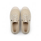 A pair of beige knit lace-up sneakers shown from a top down view.