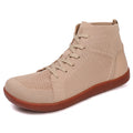 Beige high top sneaker with brown soles.