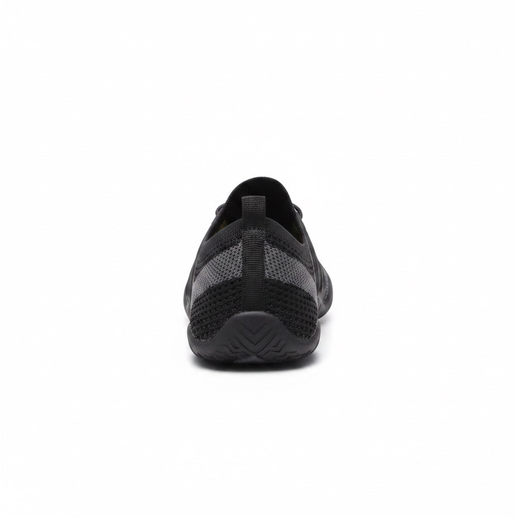 Rear view of a black barefoot shoe showing the heel and flexible sole