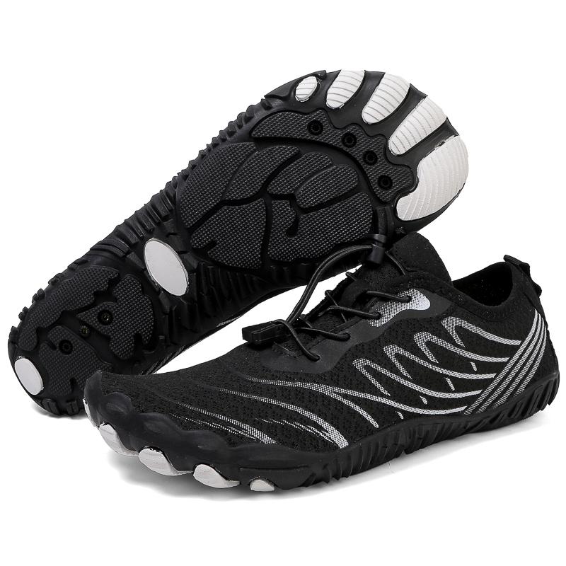 Pair of black barefoot shoes displaying the overall shape and flexible sole design.