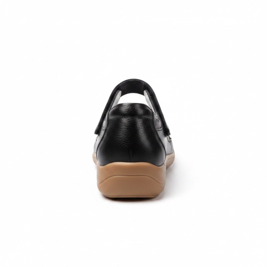Rear view of a black comfort sandal showing the heel strap and brown outsole