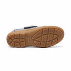 Bottom view of a grey women's comfort sandal showing its textured brown rubber sole
