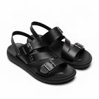 Pair of black minimalist barefoot sandals shown from an angled view
