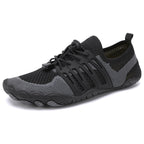 Black unisex barefoot shoe shown from the side with breathable mesh upper and flexible sole