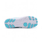 Bottom view of a light blue barefoot water shoe showing its textured flexible sole