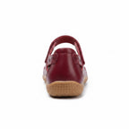 Rear view of a burgundy comfort sandal with adjustable heel strap and brown sole