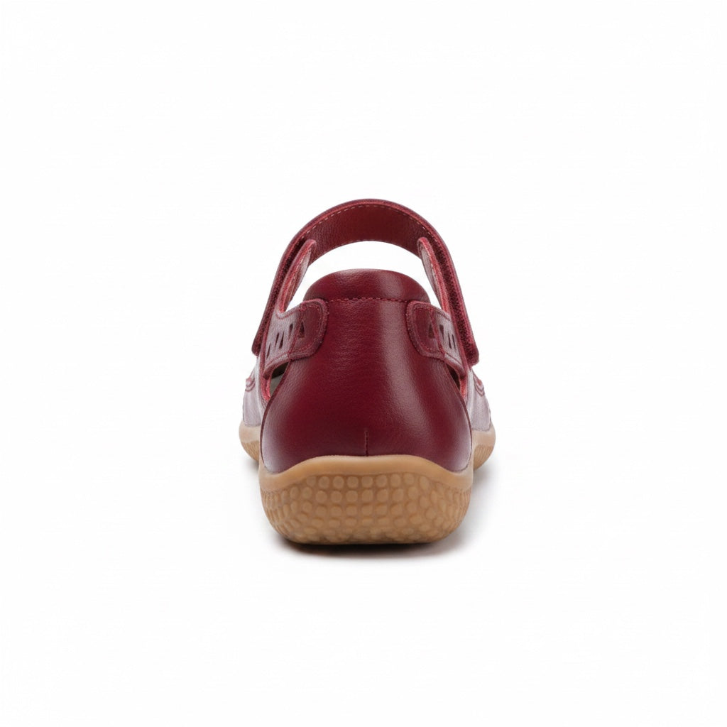 Rear view of a burgundy comfort sandal with adjustable heel strap and brown sole