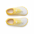 A pair of slip on water shoes in white and yellow, shown from a top down view.