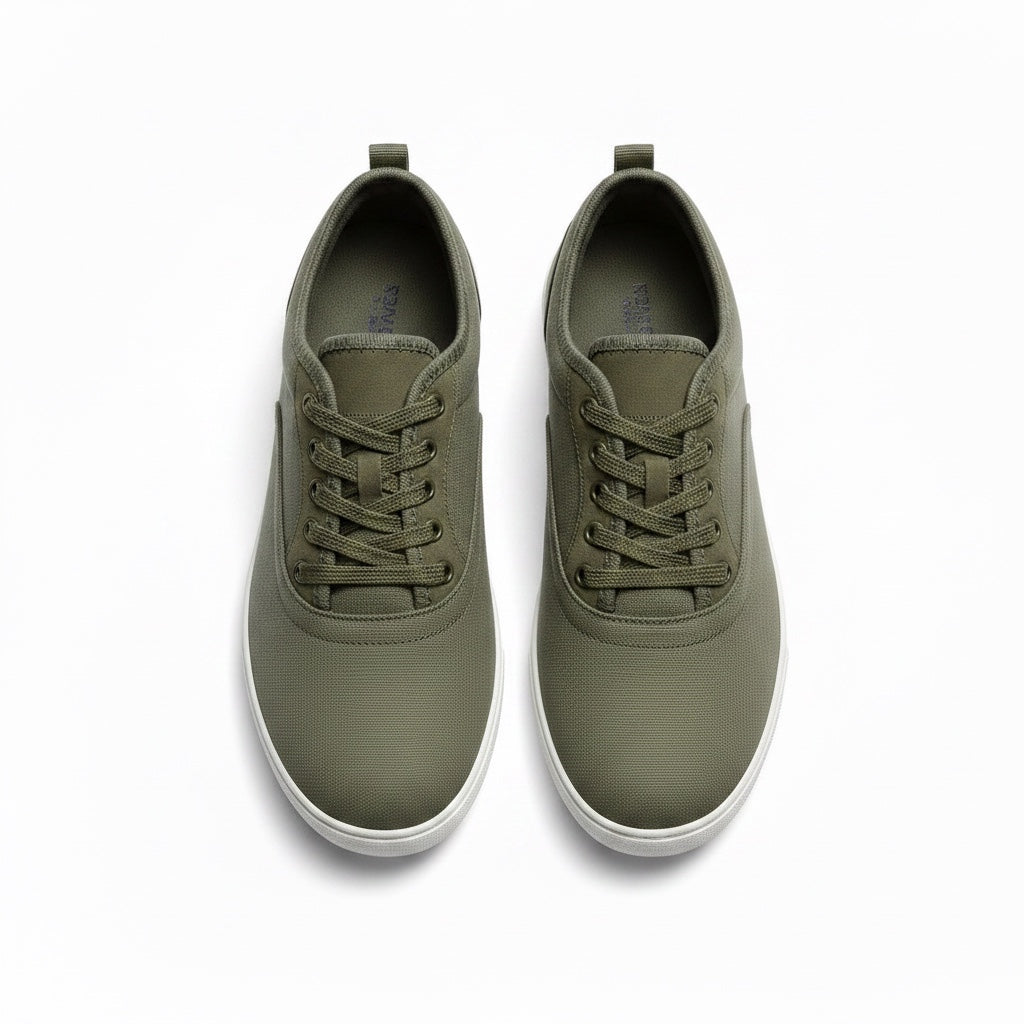 A pair of low top lace up Barefoot shoes in green with white rubber soles.