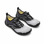 A pair of minimalist water shoes in gray and black with a bright yellow interior lining.