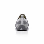 Rear view of a grey barefoot shoe showing the heel and flexible sole