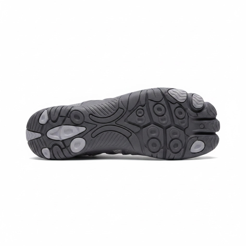 Bottom view of a grey barefoot shoe showing its textured rubber sole