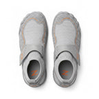 A pair of light grey Children's  slip on shoes with orange accents and a hook and loop strap, shown from a top down view.