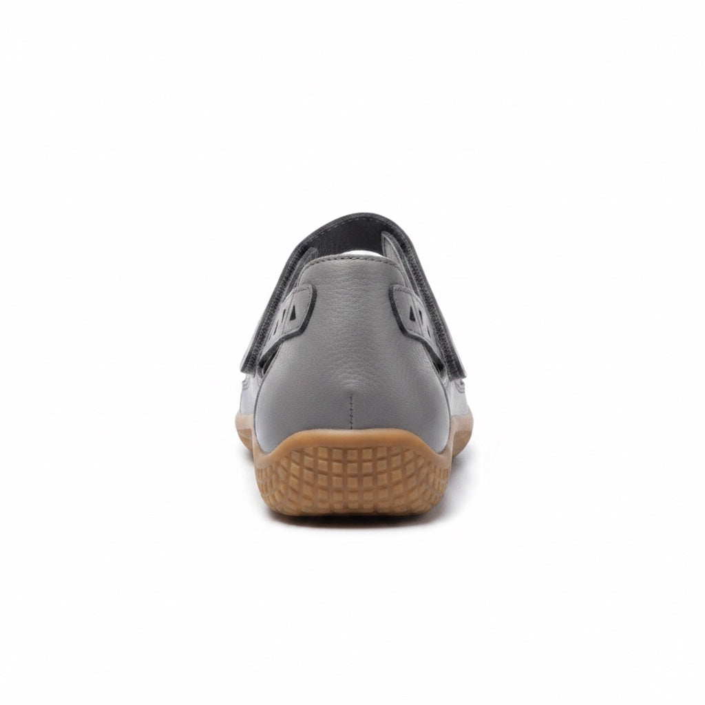 Rear view of a grey comfort sandal with adjustable heel strap and brown sole