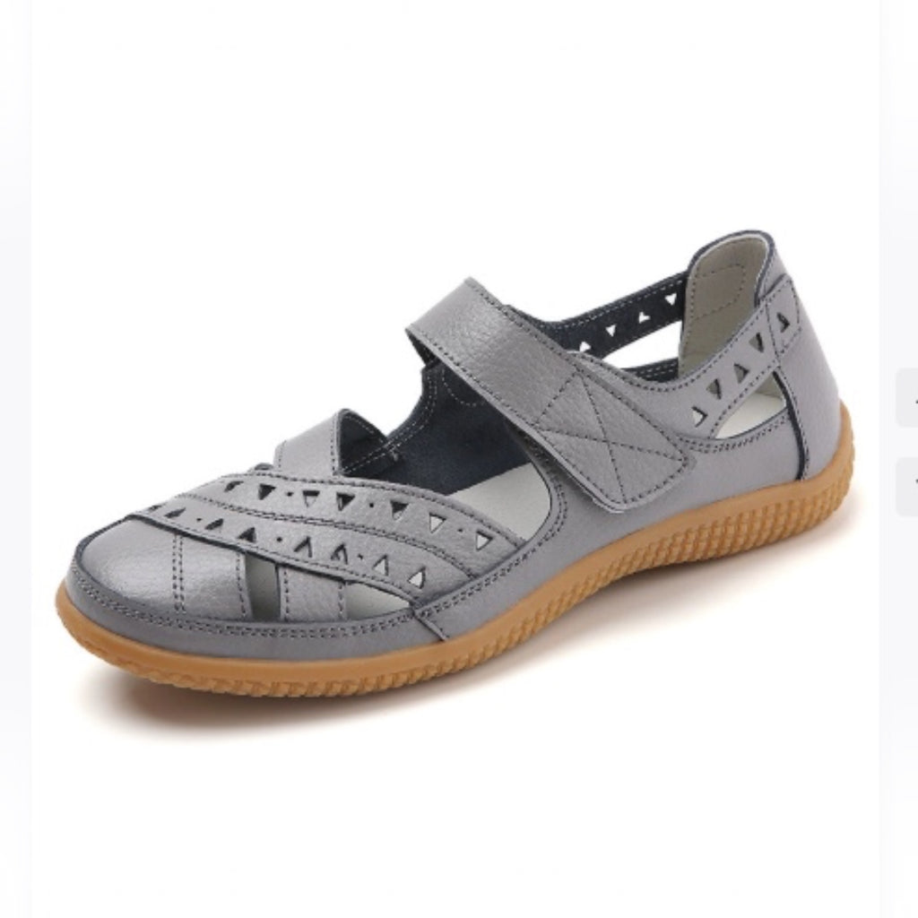 Grey women's comfort sandal with adjustable strap, perforated upper, and flexible sole