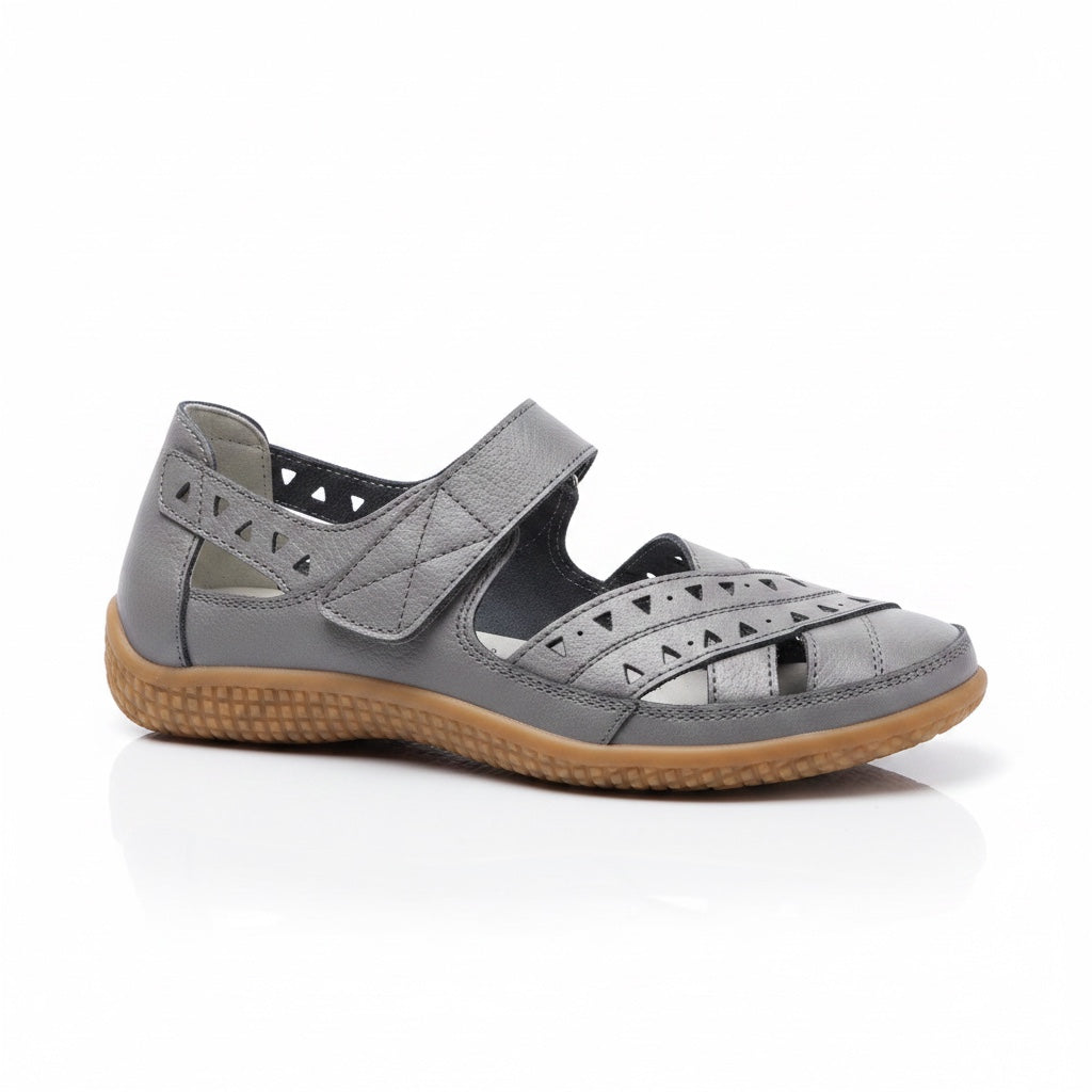 Grey women's comfort sandal with adjustable straps, cutout details, and brown sole