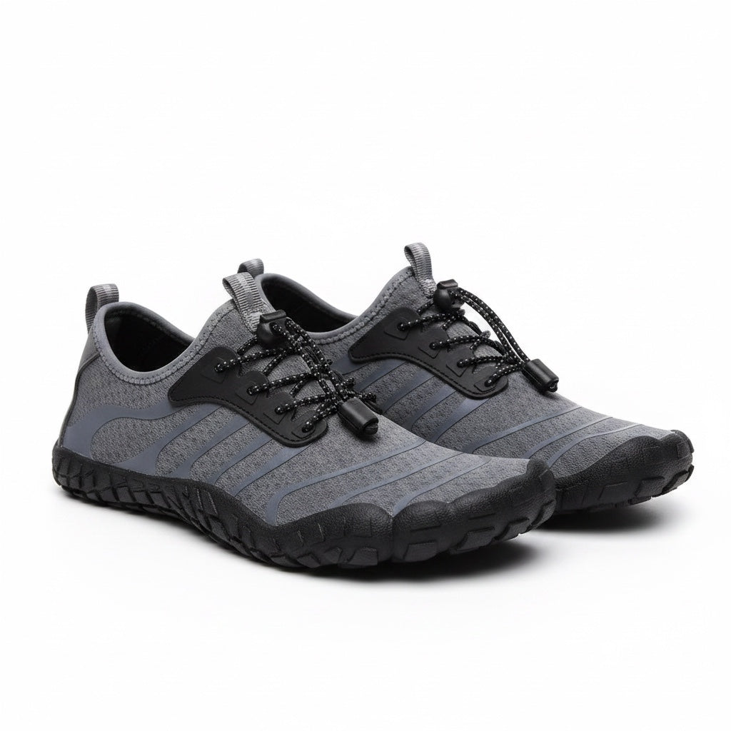 Grey unisex Flow barefoot shoes with black sole and laces. These barefoot shoes have a wide toe for pain relief for the ultimate comfort.