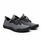 Grey unisex Flow barefoot shoes with black sole and laces. These barefoot shoes have a wide toe for pain relief for the ultimate comfort.
