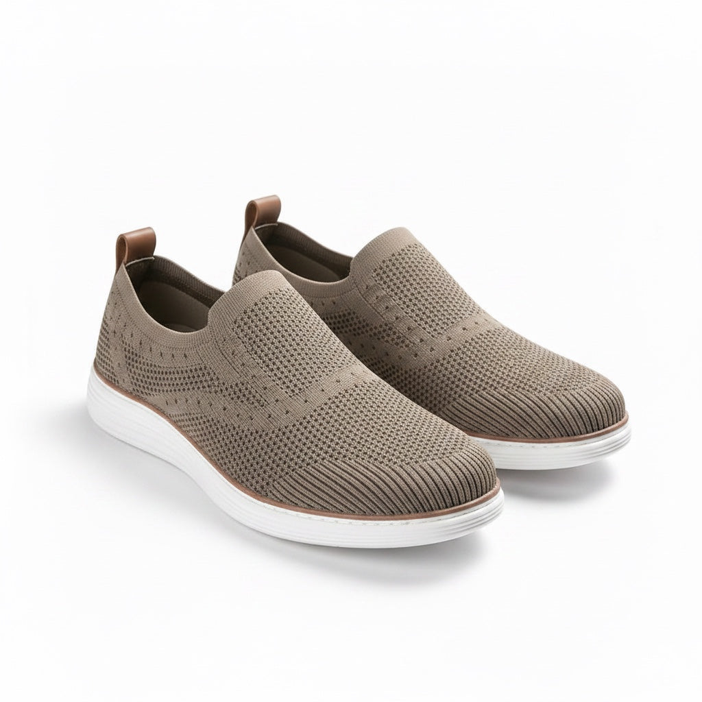 A pair of slip On knit sneakers in taupe brown with white soles.