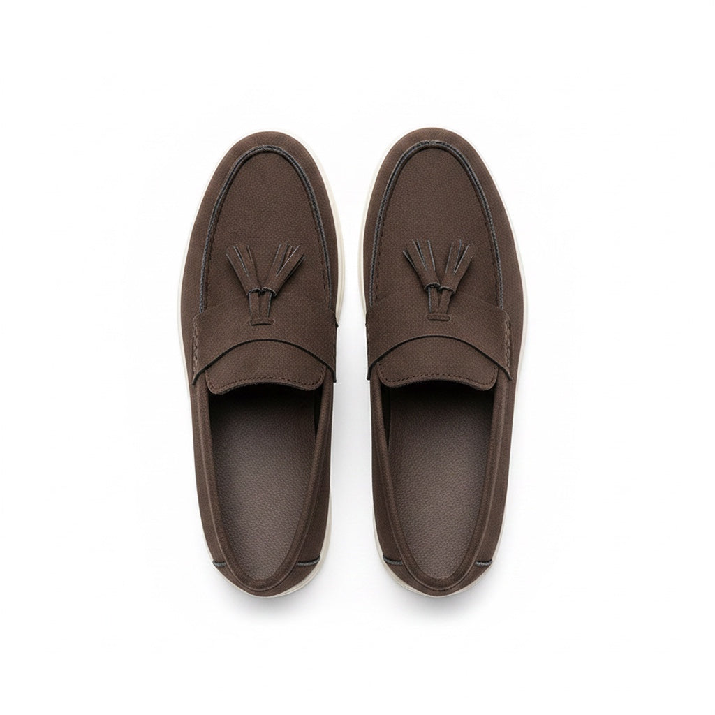 A pair of dark brown leather tassel loafers shown from a top down view.
