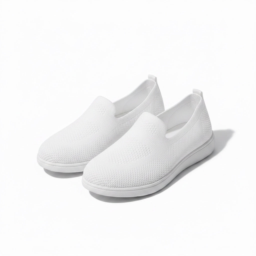 A pair of white slip on mesh loafers shoes with white soles.