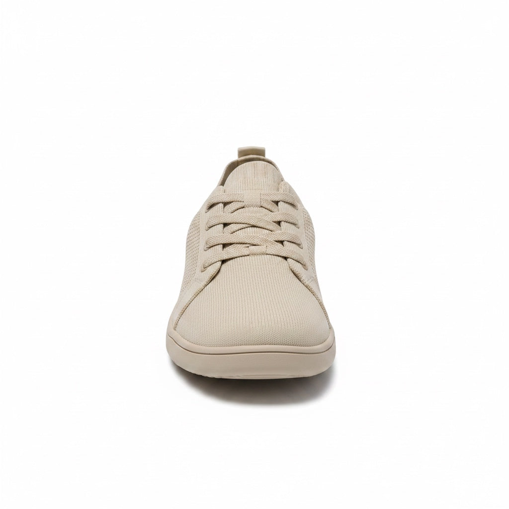 Front view of a beige men's knit barefoot shoe with matching laces and rounded toe.