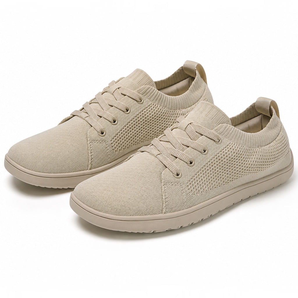 Pair of beige men's knit barefoot shoe with matching laces and lightweight rubber soles.