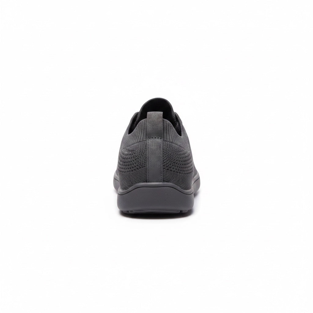 Rear view of a black men's knit barefoot shoe showing the heel construction and knit upper.